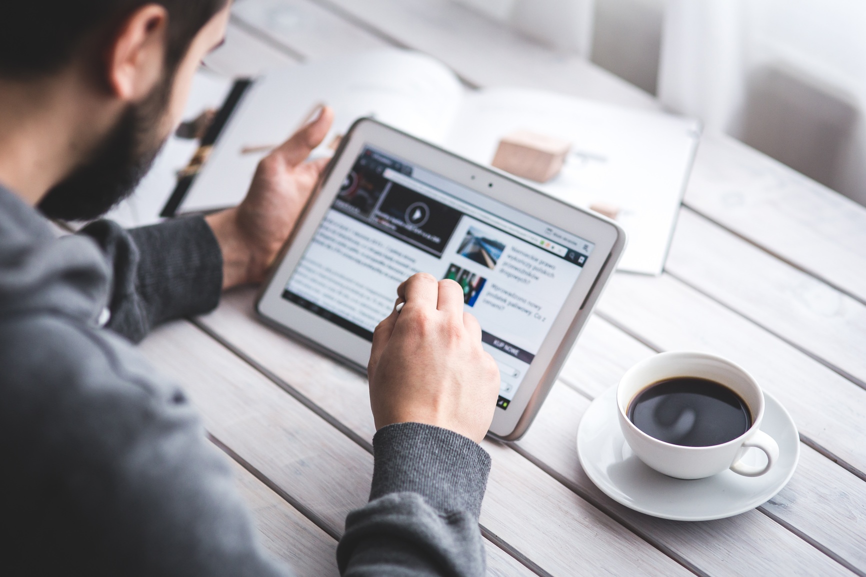 worker-reading-news-with-tablet.jpg